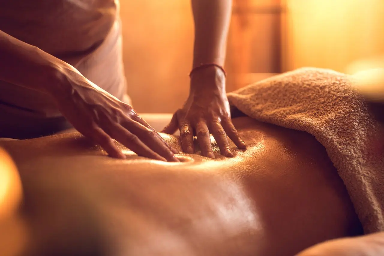 Close-up of warm oil Balinese massage on the back, offering deep relaxation and stress relief in Basavanagudi