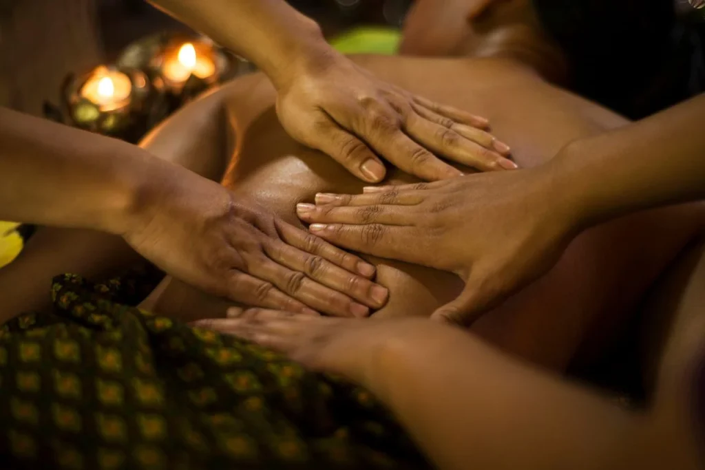 Multiple therapists performing a calm thai massage.