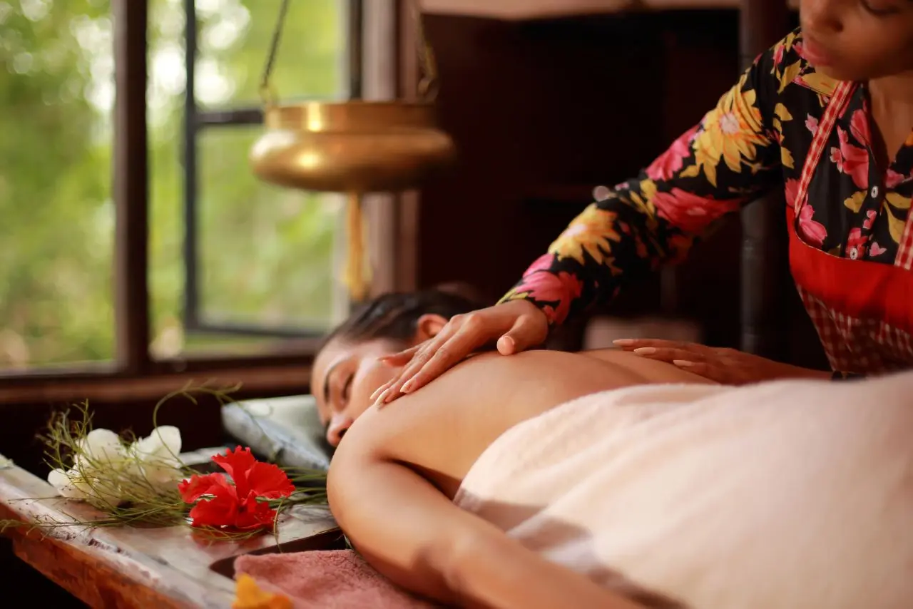 Therapist performing traditional Best Balinese Massage in Basavanagudi on a woman in a serene, nature-inspired spa in Basavanagudi